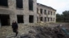 Поліцейський йде біля будівлі школи, пошкодженої російським військовим ударом, під час нападу Росії на Україну, у селищі Костянтинівка Донецької області, Україна, 22 травня 2022 року. Фото зроблено 22 травня 2022 року. REUTERS /Ганна Кудрявцева