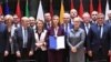 European Union foreign policy chief Federica Mogherini, center, poses with EU foreign and defense ministers after signing the notification on Permanent Structure Cooperation (PESCO) on the margin of a foreign affairs council at the Europa building in Brussels, Monday, Nov. 13, 2017. 
