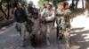 Afghan security forces escort a captured suspected Taliban insurgent during an operation in Jalalabad province in this June 19, 2013, file photo.