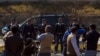 A car carrying former Pakistani President Pervez Musharraf, drives past members of the media as he leaves the special court formed to try him for treason in Islamabad Feb. 18, 2014.