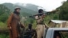 FILE - Pakistani Taliban patrol in their stronghold of Shawal in Pakistani tribal region of South Waziristan.