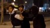 FILE - Tunisian security forces detain a protester on the outskirts of Tunis, Jan. 10, 2018.