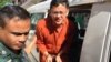 Ny Chakrya, National Election Committee officer, was escorted by the security officers to the appeal court on November 28, 2016, Phnom Penh, Cambodia. (Kann Vicheika/VOA Khmer)