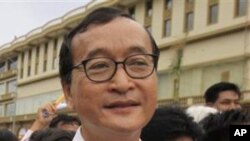 Cambodian opposition party leader Sam Rainsy, stands in front of the municipal court in Phnom Penh.