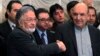 Afghan presidential candidate Qayum Karzai (R) shakes hand with fellow presidential candidate Zalmai Rassoul during a news conference in Kabul, March 6, 2014.