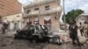 FILE - A Somali soldier stands on guard next to a destroyed car near a popular mall after a car bomb attack in Mogadishu, Somalia, July 30, 2017. The Somalia-based extremist group al-Shabab often carries out deadly bombings in Mogadishu. 