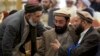 Afghanistan's former Prime Minister Ahmad Shah Ahamdzai, right, talks with an Afghan delegate as Ghairat Baheer, center, head of political cell Hizb-e-Islami Afghanistan listens during a conference title 'Peace and Reconciliation in Afghanistan', in Islamabad, Pakistan, Jan. 28, 2014.