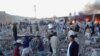 People gather after a bomb targeting Shiite Muslims exploded in busy market in Hazara town, an area dominated by Shiites on the outskirts of Quetta, on Feb. 16, 2013.