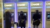 FILE - Customers uses ATM's at at a branch of Chase Bank.