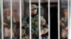 Pakistani army soldiers guard the parliament building during an emergency session in Islamabad as thousands of protesters demanding the prime minister's resignation, Sept. 2, 2014.