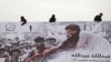 FILE - Afghans erect an election poster of presidential election candidate, Abdullah Abdullah in Kabul, Afghanistan. 