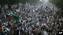 Supporters of the Pakistan Defense Council, a coalition of Islamic parties, take part in a rally to condemn U.S. drone attacks in Pakistani tribal areas, Sunday, Dec. 1, 2013 in Lahore, Pakistan.