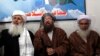 Maulana Sami ul-Haq (C), one of the Taliban negotiators, answers a question during a news conference with his team members Ibrahim Khan (L) and Maulana Abdul Aziz (R) in Islamabad February 4, 2014.