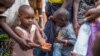 FILE - A refugee boy from Burundi who fled violence and political tension washes his hands at the Nyarugusu refugee camp in western Tanzania.