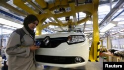 FILE - A female employee works in a Renault factory in Oran, west of Algiers.