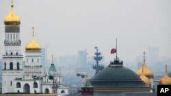 The Russian national flag is flown at half-mast on top of the Senate Building in the Kremlin on the day of national mourning in Moscow, Russia, Nov. 1, 2015.