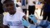 FILE - A World Health Organization (WHO) worker administers a vaccination during the launch of a campaign aimed at beating an outbreak of Ebola in Mbandaka, Democratic Republic of Congo, May 21, 2018. 