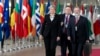 British Prime Minister Theresa May, left, arrives for an EU summit at the Europa building in Brussels, March 23, 2018.