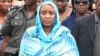 Turai Yar'Adua, wife of late President Umaru Yar'Adua, stands with Patience Jonathan as her husband's body is loaded into a plane to be transported for burial in Katsina.