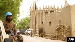 FILE - A peacekeeper with the United Nations patrols outside the mosque in Mopti, central Mali, May 30, 2018.