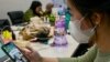Seorang wanita menonton live streaming TikTok yang menawarkan merchandise untuk dijual di Jakarta. (Foto: AFP)