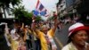 Anti-government protesters marching in the city center celebrate shortly after a Thai court delivered its verdict on Prime Minister Yingluck Shinawatra, in Bangkok May 7, 2014.