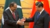 FILE - Pakistan's President Mamnoon Hussain (L) shakes hands with China's President Xi Jinping during a signing ceremony at the Great Hall of the People in Beijing.