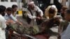 People carry an injured security officer to a hospital in Quetta, Pakistan, Aug. 8, 2013.
