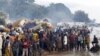 FILE - Burundian refugees gather on the shores of Lake Tanganyika in Kagunga village in Kigoma region in western Tanzania, as they wait for MV Liemba to transport them to Kigoma township, May 17, 2015. 