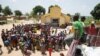 FILE - People queue for food aid distribution delivered by the United Nations Office for the Coordination of Humanitarian Affairs and world food program in the village of Makunzi Wali, Central African Republic, April 27, 2017.