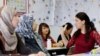 FILE - Migrants attend a lesson at the "institute for intercultural communication" in Berlin, Germany, April 13, 2016.