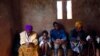 FILE - HIV-positive members of a self-help group pray at the start of a meeting in the village of Michelo, southern Zambia, Feb. 23, 2015.