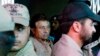 Pakistan's former president and head of the All Pakistan Muslim League (APML) political party Pervez Musharraf (C) is escorted by security officials as he leaves an anti-terrorism court in Islamabad, April 20, 2013. 