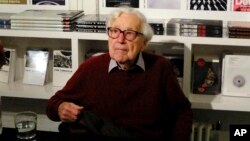 FILE - Former Life Magazine, New York Times and Washington Post picture editor John Morris during an interview in New York City, Oct. 14, 2014.