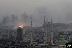 Dec. 5, 2016 file photo, a ball of fire rises following an air strike hits insurgents positions in eastern neighborhoods of Aleppo, Syria.