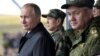 Russian President Vladimir Putin, Defense Minister Sergei Shoigu and Chinese Defense Minister Wei Fenghe watch the military parade during Vostok-2018 (East-2018) war games at Tsugol military training ground in Zabaikalsky region, Russia, Sept. 13, 2018.