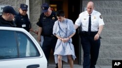 Alex Hribal, the suspect in the stabbings at the Franklin Regional High School near Pittsburgh, is taken from a district magistrate in Export, Pennsylvania, April 9, 2014. 