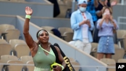 Serena Williams melambai ke kerumunan kecil saat dia meninggalkan lapangan menyusul kekalahannya dari petenis Kazakhstan Elena Rybakina pada hari kedelapan turnamen tenis Prancis Terbuka di Roland Garros di Paris, Prancis, 6 Juni 2021.