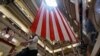 A shopper walks past a 100-foot U.S. flag that will be on display to honor veterans until July 4th, in a department store in Chicago, Illinois, May 23, 2014. 