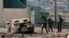 FILE - Iraqi Army soldiers inspect a suicide car bomb in a neighborhood recently liberated from Islamic State militants on the eastern side of Mosul, Iraq, Sunday, Jan. 8, 2017. 