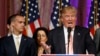 Campaign manager Corey Lewandowski looks to Republican presidential candidate Donald Trump at a supporters' rally in Palm Beach, Florida, March 15, 2016. 