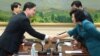 In this photo released by the South Korean Unification Ministry, South Korea's Unification Policy Officer Chun Hae-sung, left, shakes hands with the head of North Korea's delegation Kim Song Hye, right, June 10, 2013.