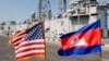 FILE: Cambodian and U.S. national flags flutter at Sihanoukville port, as the guided missile grigate USS Gary is docked in the background in Sihanoukville, some 185 kilometers (115 miles) southwest of Phnom Penh, Cambodia's capital, Friday, Feb. 9, 2007. The U.S. navy warship docked at Cambodia's main sea port Friday in its first visit in more than three decades to the impoverished Southeast Asian nation. (AP Photo/Heng Sinith)