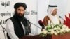 Muhammad Naeem (L), a spokesman for the Office of the Taliban of Afghanistan, speaks during the opening of the Taliban Afghanistan Political Office in Doha, June 18, 2013. 