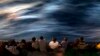 FILE - Migrants and refugees stand on the deck of the rescue vessel Golfo Azzurro after being rescued by Spanish NGO Proactiva Open Arms workers on the Mediterranean Sea, June 16, 2017. 