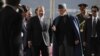 Afghan President Hamid Karzai, center right, talks with Pakistan's Prime Minister Nawaz Sharif while they inspect a guard of honor in Kabul, Afghanistan, Nov 30, 2013. 