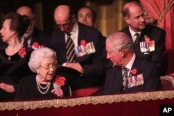 Queen Elizabeth II (left, front) and Prince Charles (right, front), and others attend the Royal British Legion Festival of Remembrance at the Royal Albert Hall in London, Nov. 10, 2018.