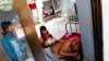 FILE - A malaria patient is comforted in the only hospital in Pailin, western Cambodia.