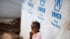 FILE - A girl eats a mango at a shelter for displaced people in Bangui, Central African Republic, April 24, 2017. 