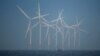 FILE - A survey vessel sails past wind turbines at the Burbo Bank offshore wind farm near New Brighton, Britain, Jan. 23, 2023.
